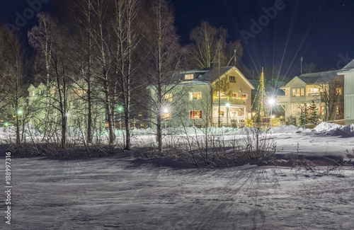 Fina och juldekorerade villor skymtar fram mellan björkarne på Gylstaudden denna klare fina vinterkväll i Luleå photo