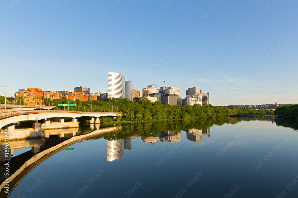 Washington DC panorama along Potomac River in an early morning, USA. Urban landscape in late spring with bridges and modern skyscrapers.