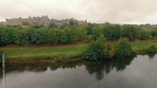 Drone shot descending over a river in Carcassonne photo