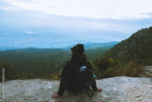 Men asians travel relax in the holiday. Admire the atmosphere landscape on the Moutain. Mountain Park happily. In Thailand photo