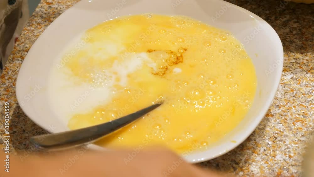 adding vanilla extract and milk to the egg mix adding vanilla extract and milk to the egg mix