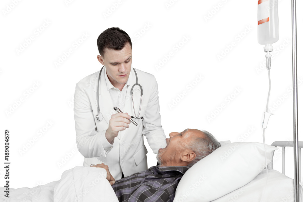 Obraz premium American doctor examining throat of his patient