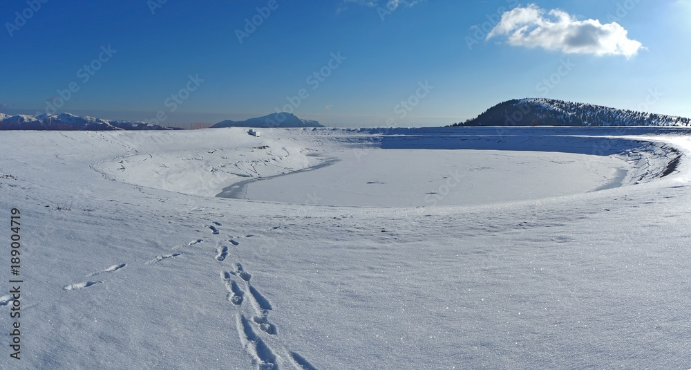 Castione della Presolana, Bergamo, Italy. Artificial water catchment reservoir for snow skiing slopes