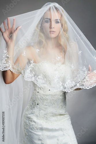 Beautiful bride woman in wedding dress and veil photo