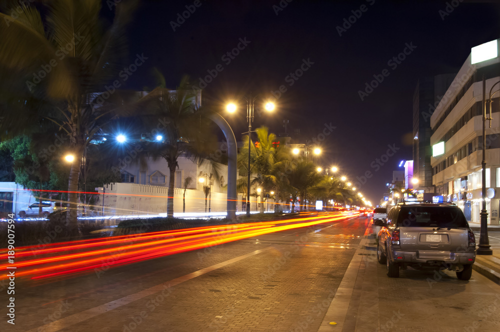 Palestine street in Jeddah at night, with car lights motion Palestine street in Jeddah at night, with car lights motion