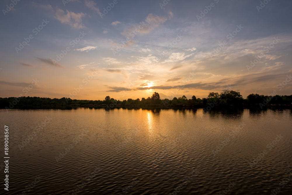 Dramatic silhouette vivid sunset sunrise  reflect on the lake background.