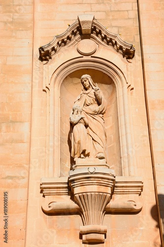 Religious statue on the front of Naxxar Parish church, Naxxar, Malta.