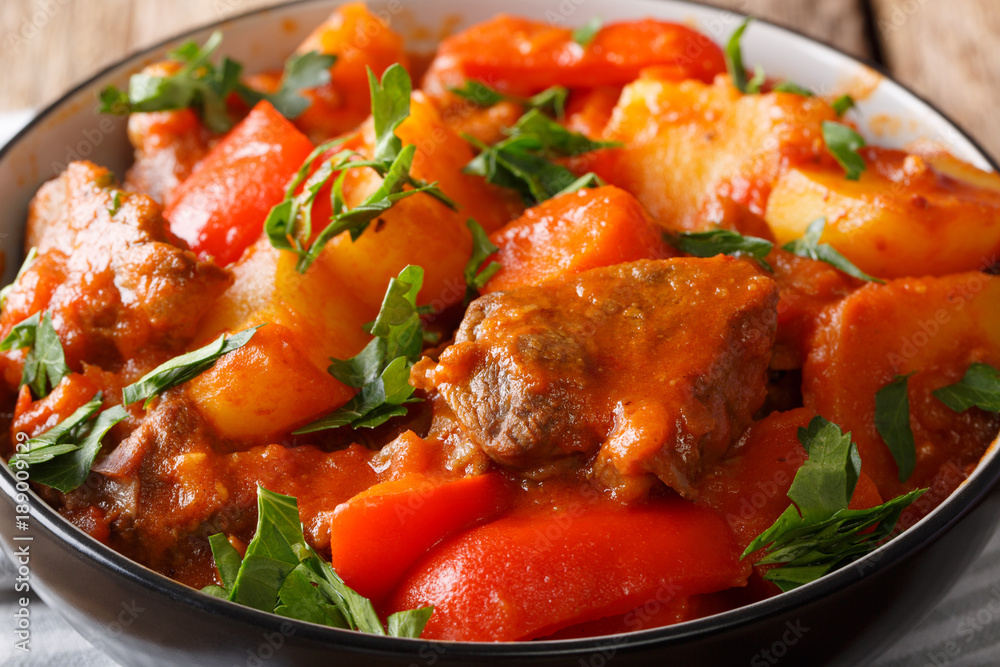 Filipino beef stew mechado with potatoes, peppers, carrots and onions close up in a bowl. horizontal Filipino beef stew mechado with potatoes, peppers, carrots and onions close up in a bowl. horizontal