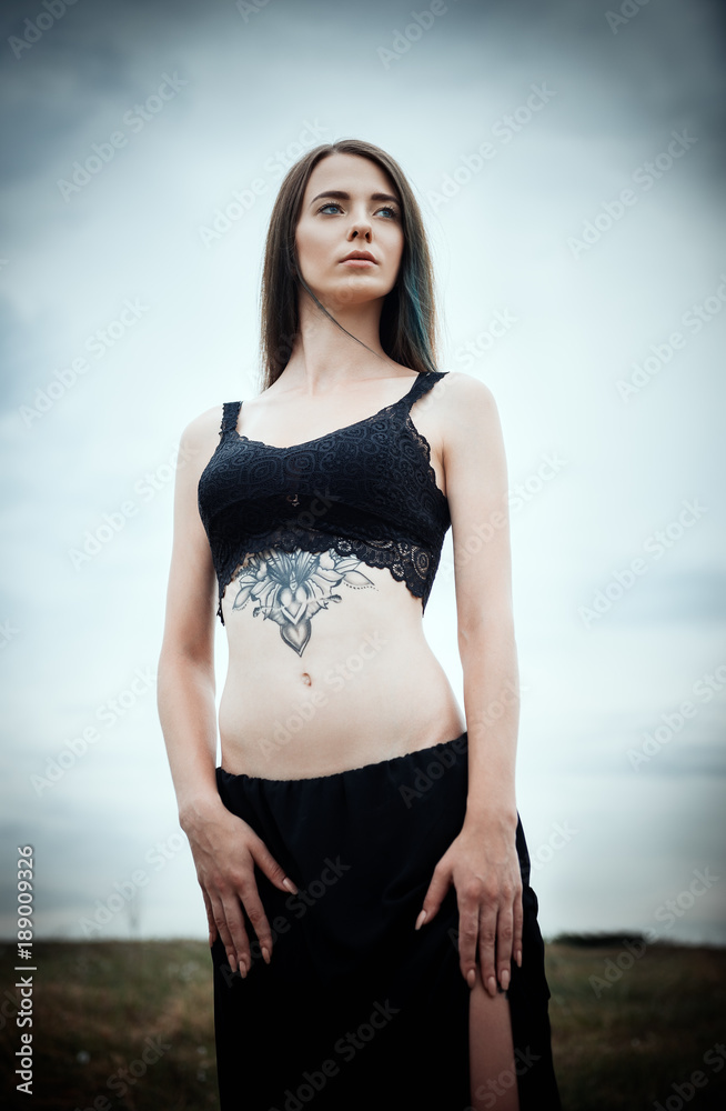 Fototapeta premium Portrait of beautiful young woman in the field