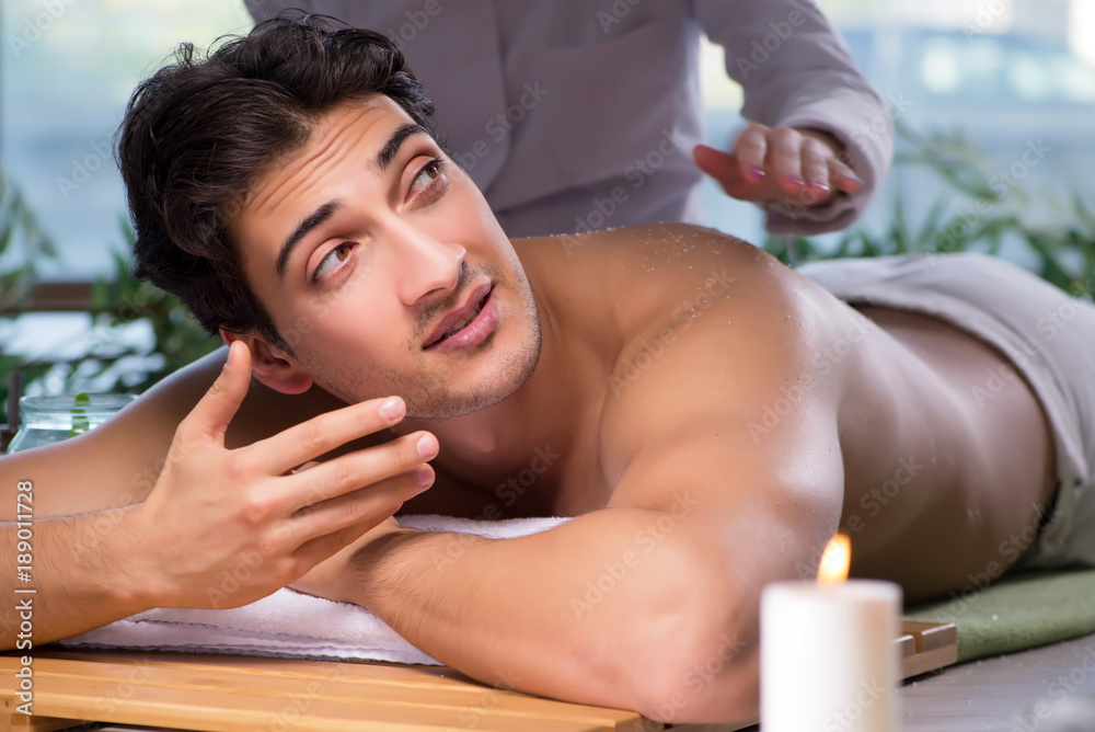 Young handsome man during spa procedure Young handsome man during spa procedure