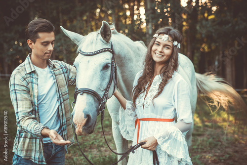 Young couple and beautiful horse