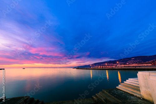 Fototapeta Naklejka Na Ścianę i Meble -  Colorful sunset in front of the city of Trieste
