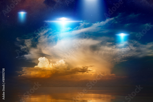 Extraterrestrial aliens spaceships, ufo in red glowing sky © IgorZh