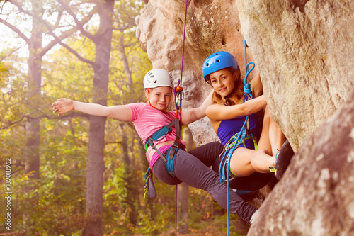 Obraz na plátne Two climbers abseiling training on steep rock