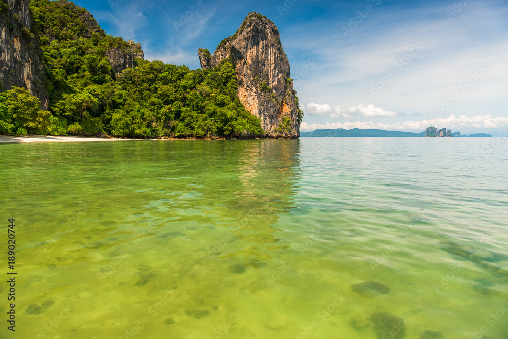 Obraz premium transparent sea water, view of the coral in a beautiful bay with high cliffs, Thailand, Krabi