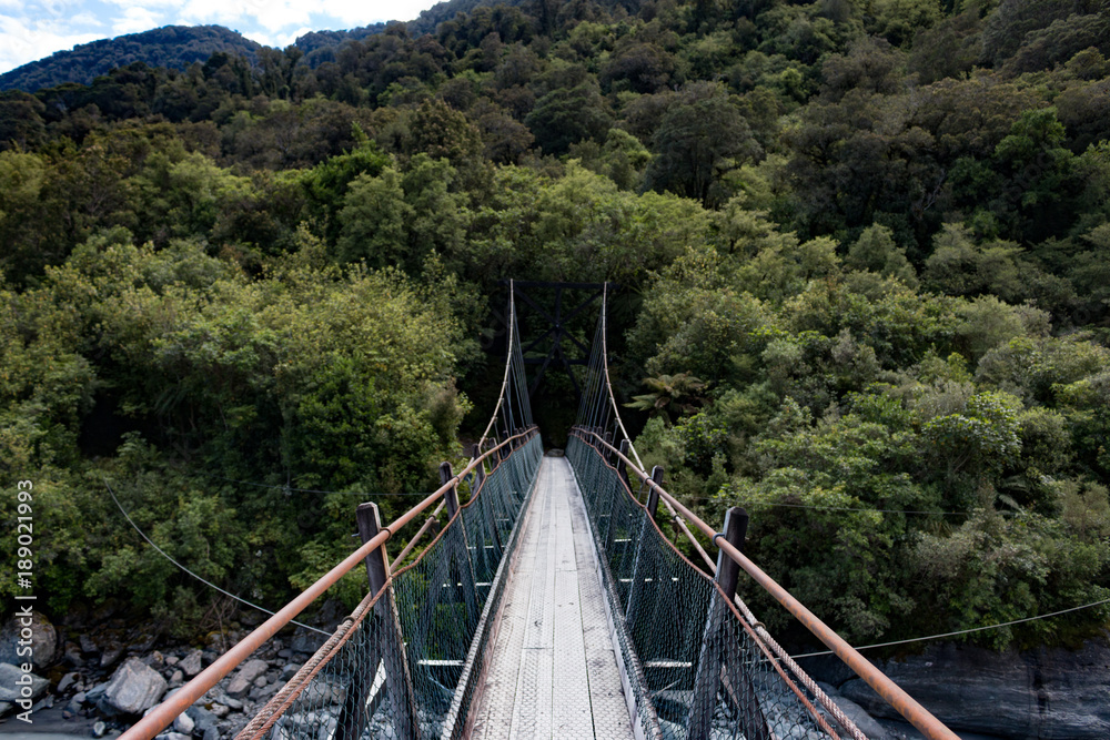 Fototapeta premium New Zealand Fox Glacier old historic wooden swing bridge