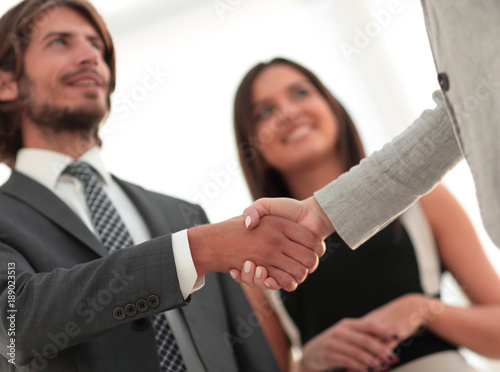 Businesspeople  shaking hands against room with large window loo © ASDF