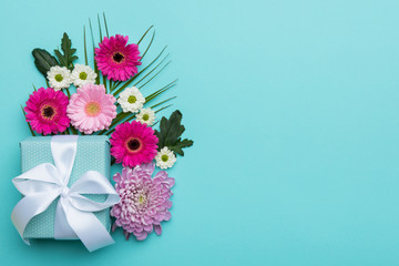 Happy Mother's Day, Women's Day, Valentine's Day or Birthday Pastel Candy Colors Background. Floral flat lay greeting card with beautifully wrapped present and copy space.