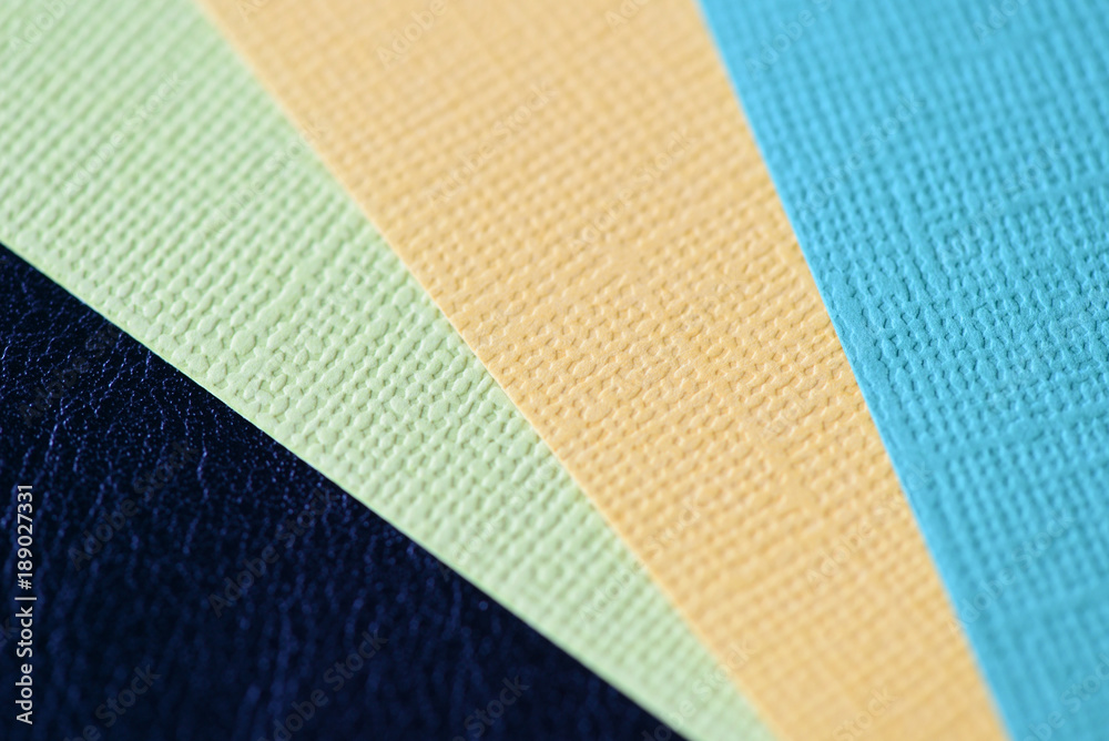 Fototapeta premium Colorful cardboads on a dark leather background close up