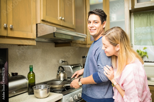 Man with girlfriend cooking in a kitchen