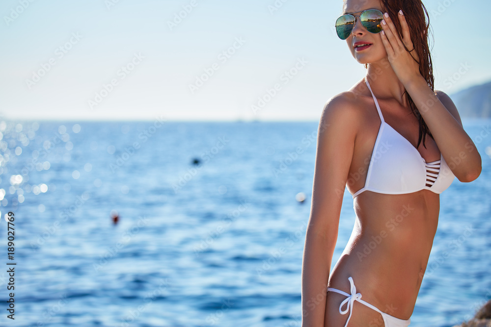 summer sunny fashion portrait of pretty young sensual redhair woman posing in bikini