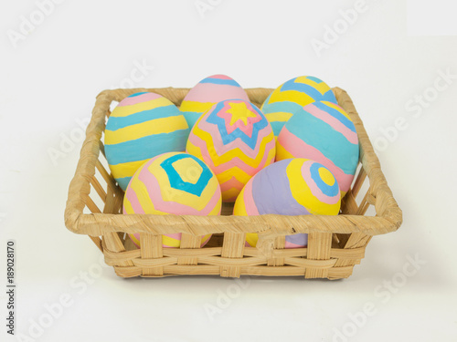 Painted easter eggs in a basket isolated on white background with clipping path, concept for Easter