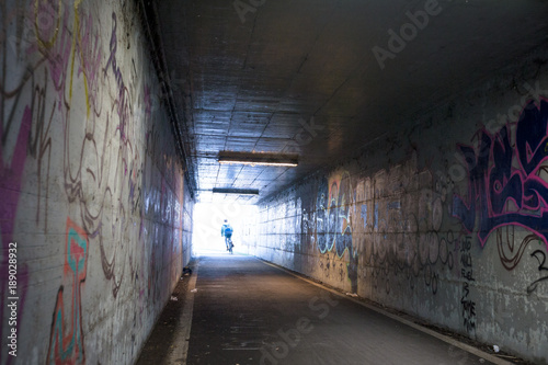 Dark underpass with graffiti on the walls. Ferrara, Italy