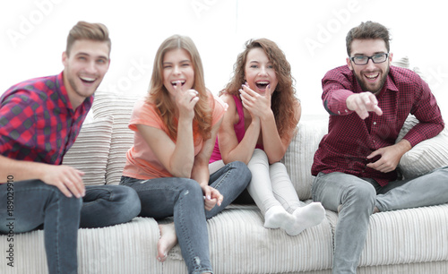 group of cheerful friends watching their favorite movie
