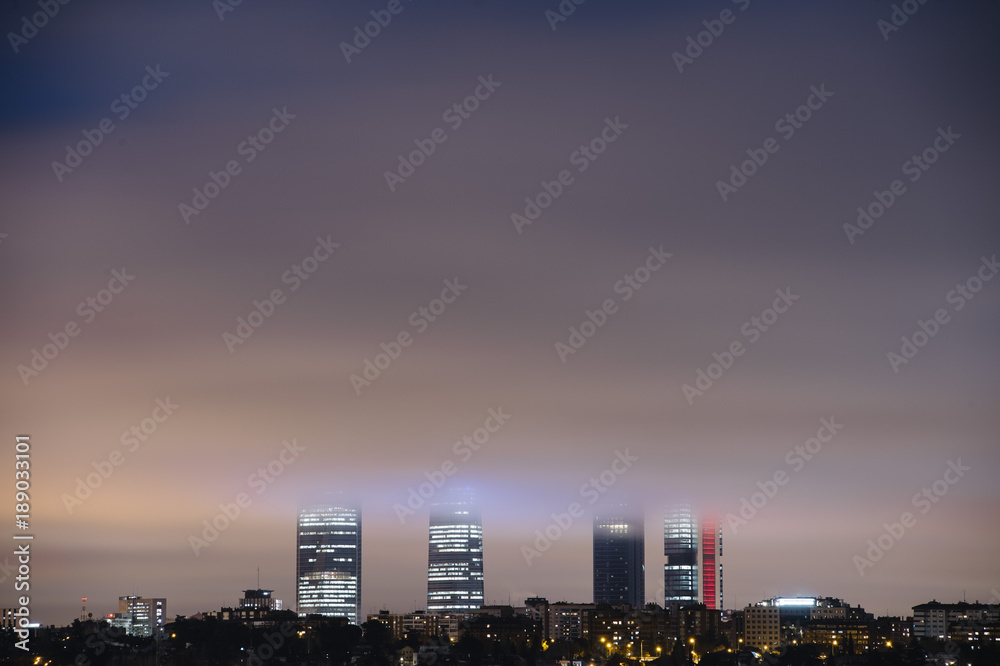 Fototapeta premium Overview of the four towers of Madrid with fog