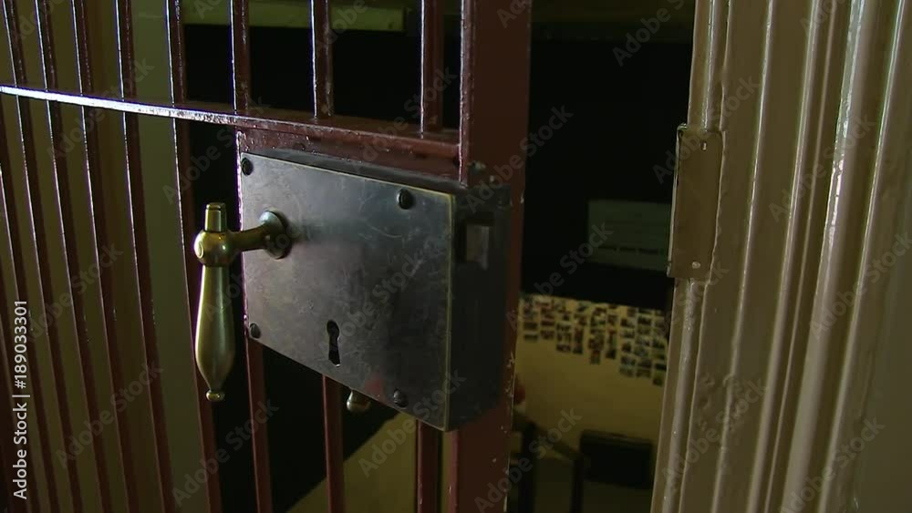 A medium shot of a door of a jail. Camera slides to the left A medium shot of a door of a jail. Camera slides to the left