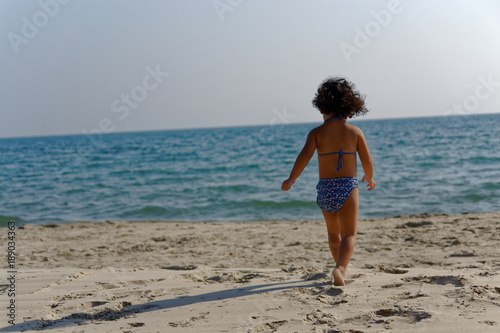 little girl walking on the beach © Nokweed