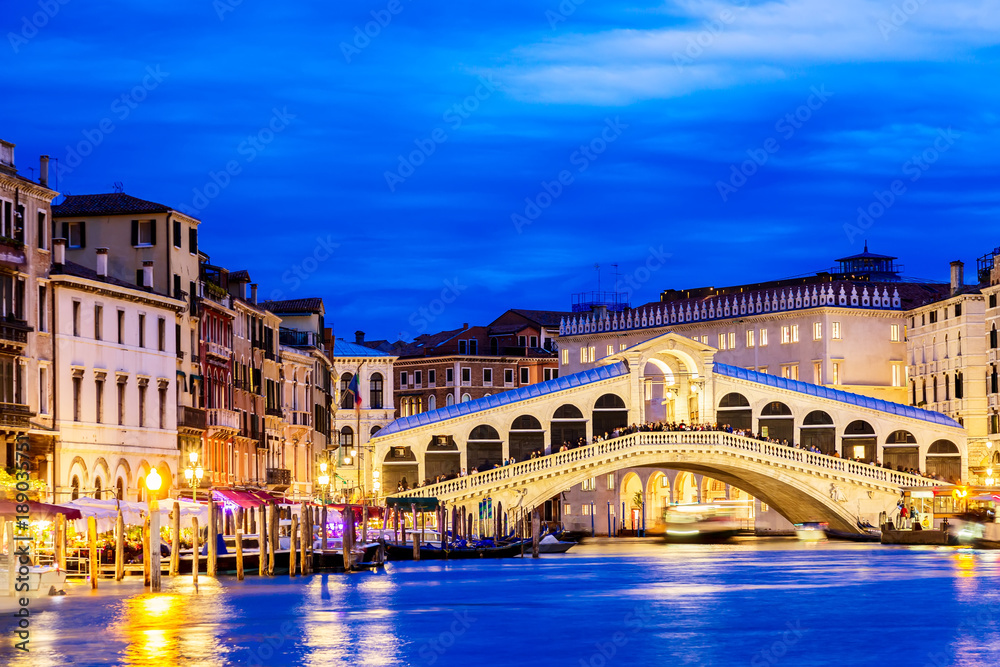 Venice, Italy. Rialto bridge and Grand Canal at twilight blue hour. Tourism and travel concept.