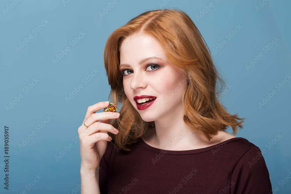 Beautiful red lips with a piece of sweet candy. Close up of young woman with candy in mouth. Beautiful red lips with a piece of sweet candy. Close up of young woman with candy in mouth.
