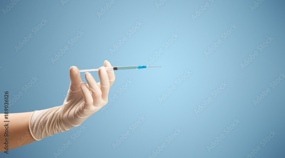 Female doctor holding syringe Female doctor holding syringe