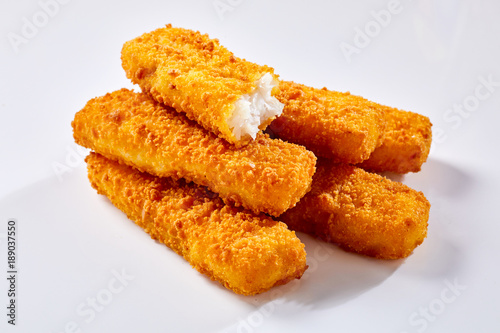 Canvas Print Crispy fish fingers against white background