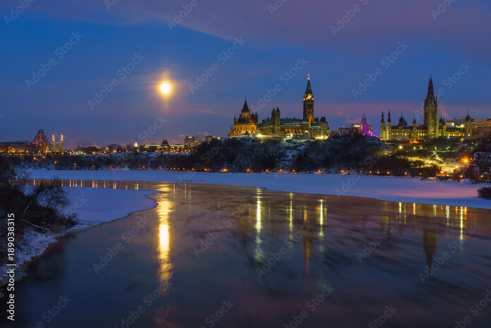 Ottawa skyline in winter under full moon