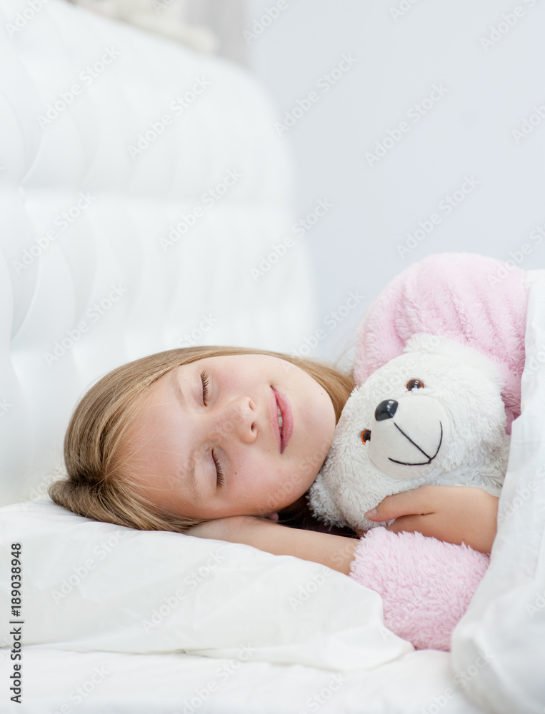 Sleeping girl hugging a toy bear Sleeping girl hugging a toy bear