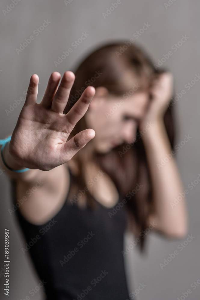 Teenage girl showing a stop sign, wanting to be left alone. Focus on the palms Teenage girl showing a stop sign, wanting to be left alone. Focus on the palms