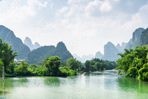 The Yulong River among green woods and scenic karst mountains © efired