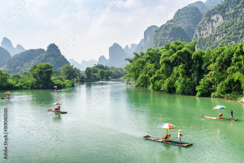 Small tourist bamboo rafts sailing along the Yulong River, China
