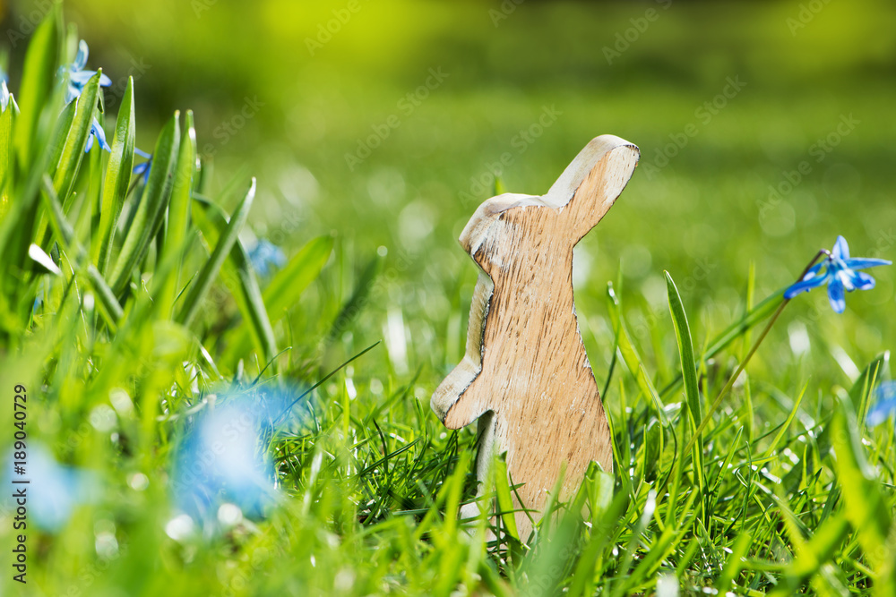 Osterhase aus Holz in einer Blumenwiese Stock Photo | Adobe Stock