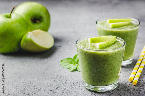 Green tea apple smoothie on concrete background. Selective focus, space for text. 