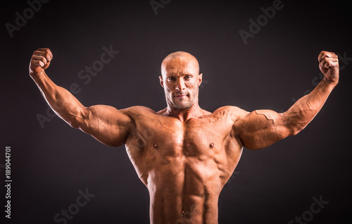 bodybuilder posing in studio