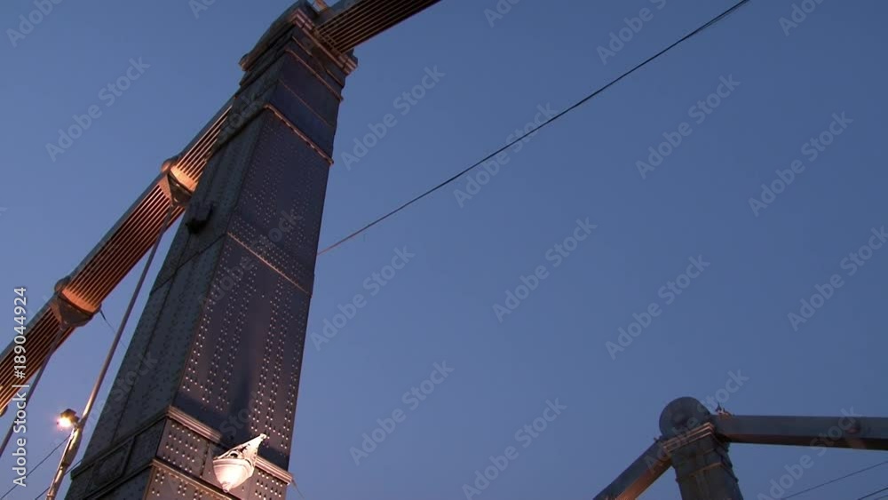 Lanterns on metal hanging bridge over river in evening Moscow. Beautiful views of capital Russia . Steel construction in big city. Lanterns on metal hanging bridge over river in evening Moscow. Beautiful views of capital Russia . Steel construction in big city.