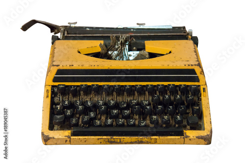 Rusty old vintage yellow typewriter isolated.