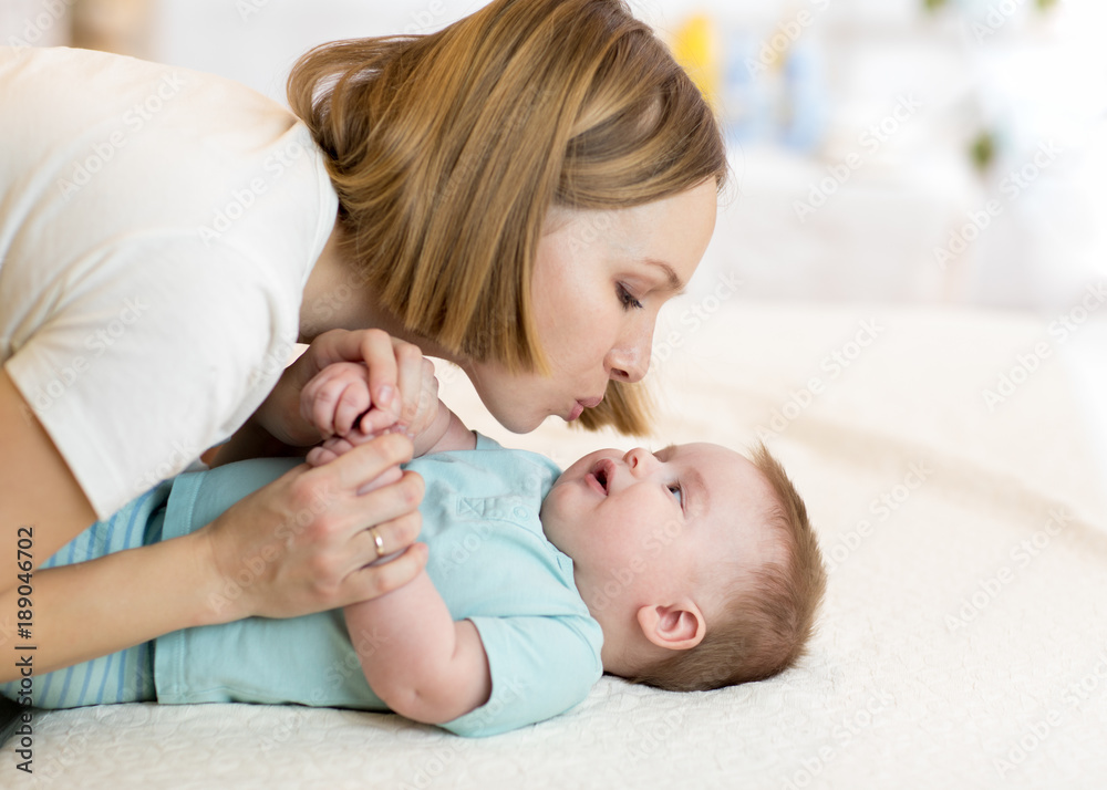 Beautiful mother kissing her baby Beautiful mother kissing her baby