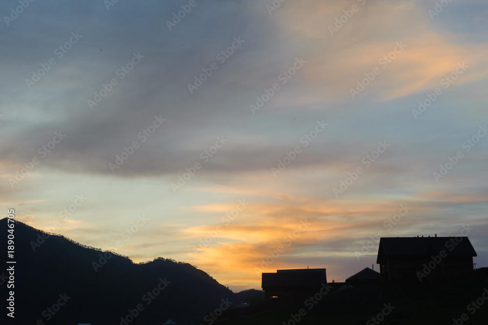 Picturesque sunset over mountain river and small village