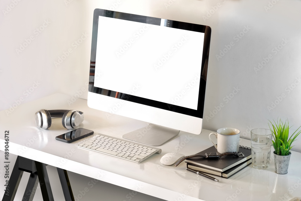 Fototapeta premium Top view workspace mockup desktop computer, coffee mug and designer office supplies on white wood.