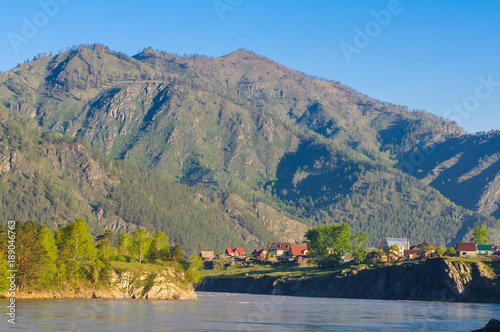 Picturesque sunset over mountain river and small village