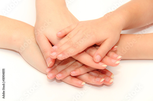Mother and daughter holding hands together, closeup